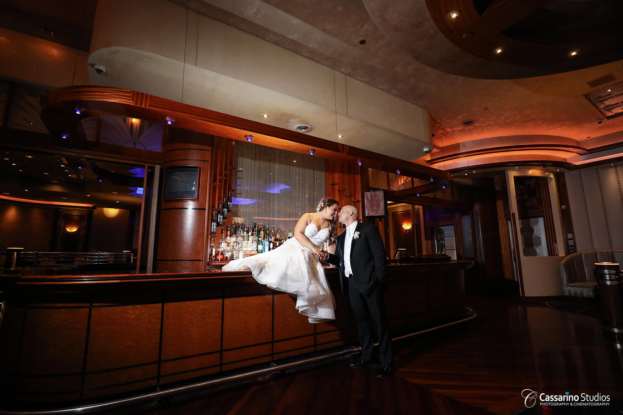 Couple kissing on indoor wedding venue bar